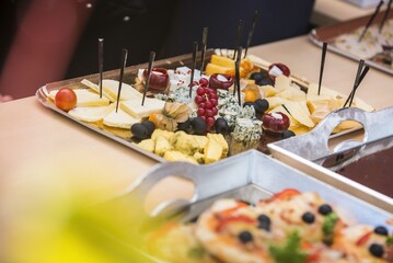 Assorted bite-sized appetizers – beautifully presented mini sandwiches, cheese and meat bites,...