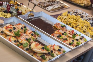 Assorted bite-sized appetizers – beautifully presented mini sandwiches, cheese and meat bites,...