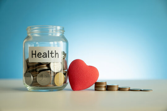 Saving for Health A Jar Full of Coins and a Red Heart Symbolize the Financial Investment in Healthcare and the Importance of Saving