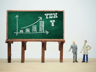 Mini toy of action figure at table with blurred background. Business financial photography concept...