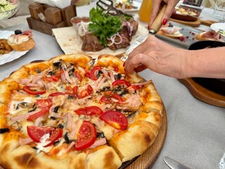Slicing pizza in a restaurant