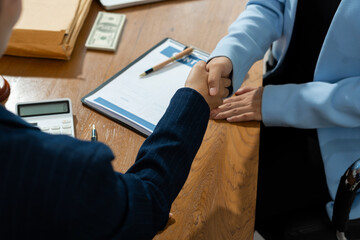 partner lawyers attorneys shaking hands after discussing a contract agreement done