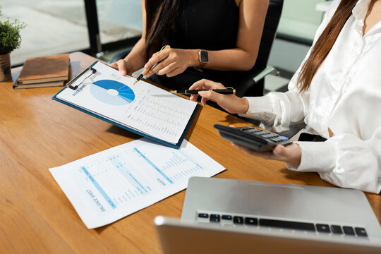 Business team to calculate financial information to invest in new projects. financial manager meeting.euing Smart phones and laptops and digital tablet PCs in modern office.