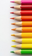 Fototapeta premium Vibrant row of sharpened colored pencils on a white background