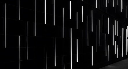 Abstract architectural detail featuring vertical illuminated lines set against a dark, textured wall, creating a rhythmic pattern.