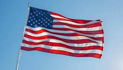Obraz premium Stars and Stripes Soaring: The iconic Stars and Stripes, the American flag, majestically flies in a bright blue sky, symbolizing freedom, unity, and national pride. A photorealistic image.