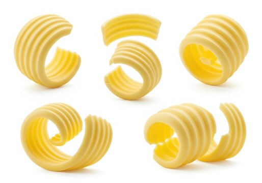 Photo of five swirls of yellow butter curls isolated on a white background, perfect for culinary and baking applications
