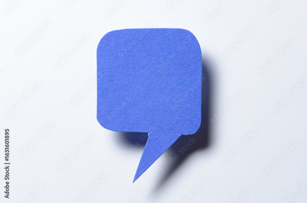 Poster blue blank cut out paper speech bubble with drop shadow and copy space for text on white background,
