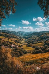 Naklejka premium Autumnal valley vista, framed by trees