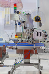 Automated Labeling Machine at Conveyor Belt in Food Factory Production  Line