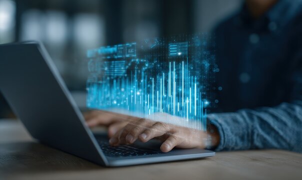Person using laptop with holographic financial data overlay