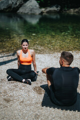 A pair of individuals practicing serene yoga poses beside a calm, clear river in nature.