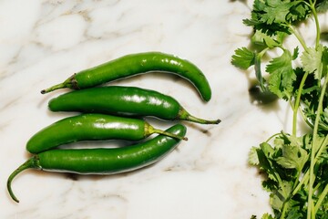 Four chili peppers on the table.
