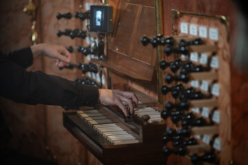 A pianist playing on an antique church organ, Detail of hands and keyboard