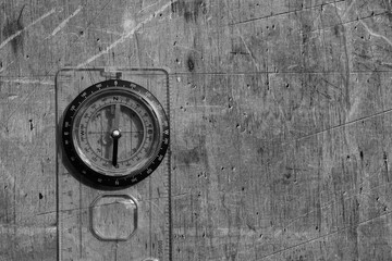 Classic navigation shiny compass on wooden background