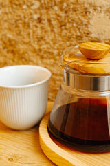 A stylish coffee brewing set featuring a glass carafe and white cup, perfect for modern coffee lovers.