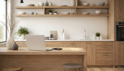 Fototapeta premium Modern kitchen with wooden island laptop workspace. Laptop rests on island next to phone. Natural light pours in through window with plant on sill. Wooden cabinets granite countertop harmonious