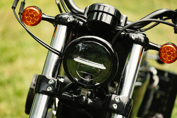 A detailed closeup of a motorcycles front view, showcasing its sleek design and prominent chrome...