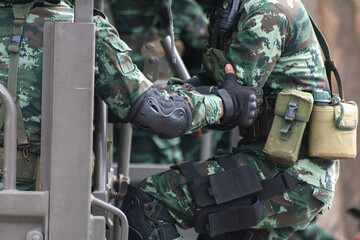 A soldier in full uniform sitting in a military truck. Represents military logistics,...