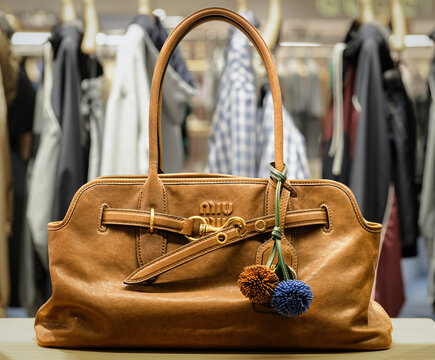 Aventure shoulder bag in cognac-coloured leather, with charms, by Miu Miu.Milan - italy,25 July 2025
