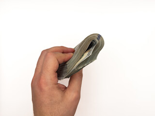 USA dollars, US money, cash, salary in dollars, dollar, mans hand is holding a stack of US dollars,...