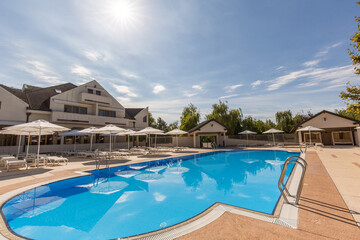 Outdoor swimming pool at a modern luxury resort on a sunny day