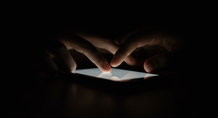 Cinematic close-up of fingers scrolling on a smartphone, phone light illuminating the dark room