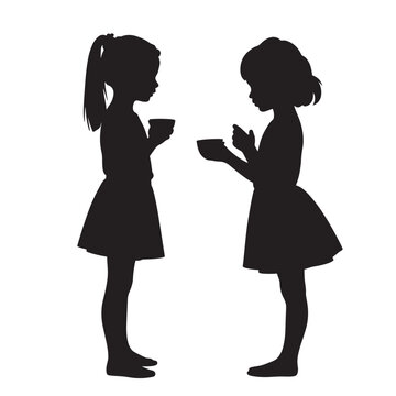 Two girls engaged in conversation while holding cups in silhouette  