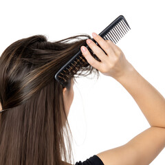 Fototapeta premium A young woman with long brown hair combs her hair with a black comb. The background is transparent, emphasizing the action of grooming.