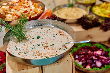 A Delightful Spread of Freshly Prepared Dishes Featuring Creamy Dip, Colorful Salads, and Tasty...