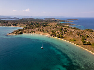 Aerial view of a scenic Mediterranean coastline with turquoise waters, sandy beaches, olive groves,...