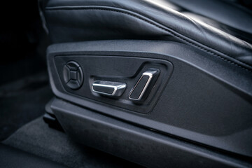 Interior of a premium electric SUV, black leather, aluminum, decorative elements.