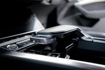 Interior of a premium electric SUV, black leather, aluminum, decorative elements.