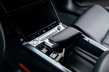 Interior of a premium electric SUV, black leather, aluminum, decorative elements.