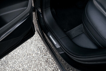 Interior of a premium electric SUV, black leather, aluminum, decorative elements.