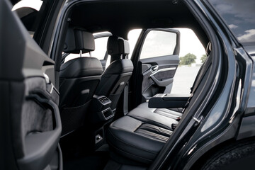 Interior of a premium electric SUV, black leather, aluminum, decorative elements.