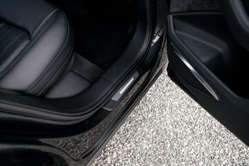 Interior of a premium electric SUV, black leather, aluminum, decorative elements.