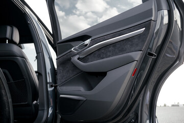 Interior of a premium electric SUV, black leather, aluminum, decorative elements.