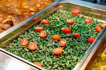 A Vibrant Dish Featuring Fresh Green Beans Topped with Juicy Cherry Tomatoes and a Light Garnish,...