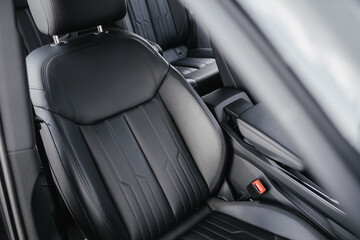 Interior of a premium electric SUV, black leather, aluminum, decorative elements.