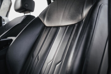 Interior of a premium electric SUV, black leather, aluminum, decorative elements.