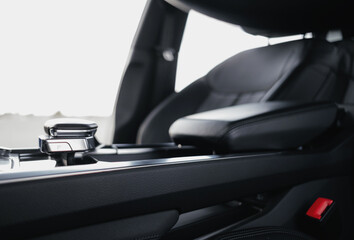 Interior of a premium electric SUV, black leather, aluminum, decorative elements.