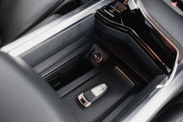 Interior of a premium electric SUV, black leather, aluminum, decorative elements.