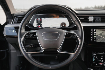 Interior of a premium electric SUV, black leather, aluminum, decorative elements.