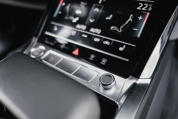 Interior of a premium electric SUV, black leather, aluminum, decorative elements.