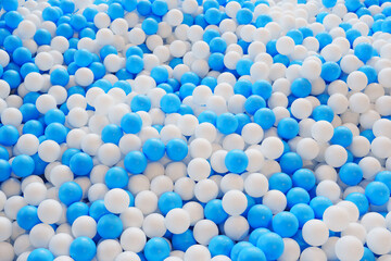 Colorful blue and white plastic balls create a playful indoor environment