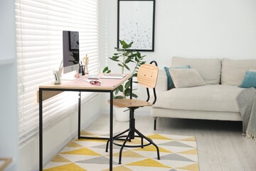 Stylish workplace with wooden desk, stationery and computer at home office. Interior design