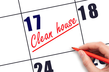 17th day of the month.  Hand writing Clean house reminder and drawing a line on calendar with red...