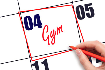 4th day of the month. Hand writing Gym reminder and drawing red frame on calendar with red pen on...