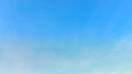 Blue sky background with white clouds in summer. Soft white clouds float in the clear blue sky. Clear blue sky, bright spring, soft sky gradient, wallpaper landscape, aerial view.